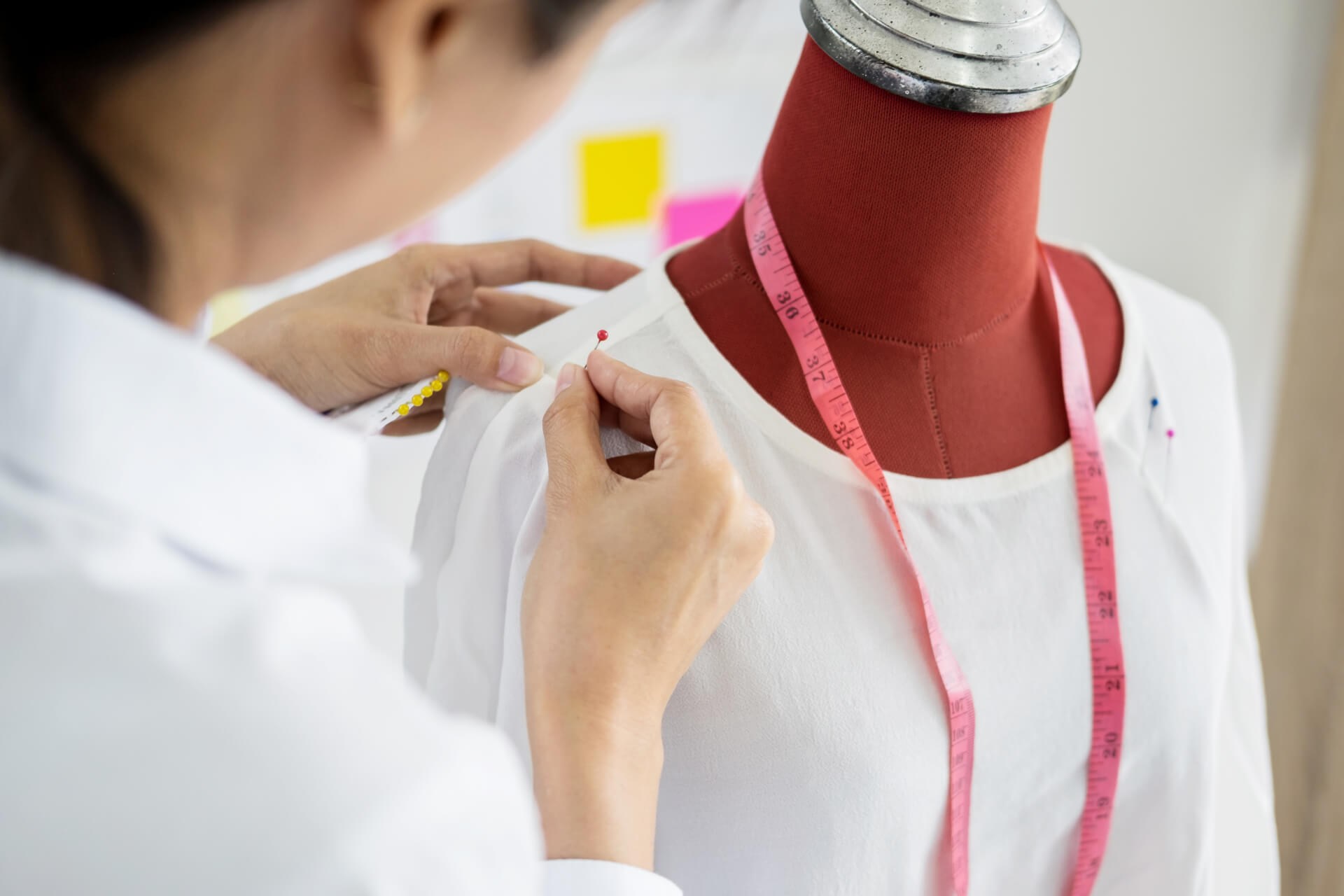 stock-photo-asian-tailor-adjusts-garment-design-on-mannequin-in ...